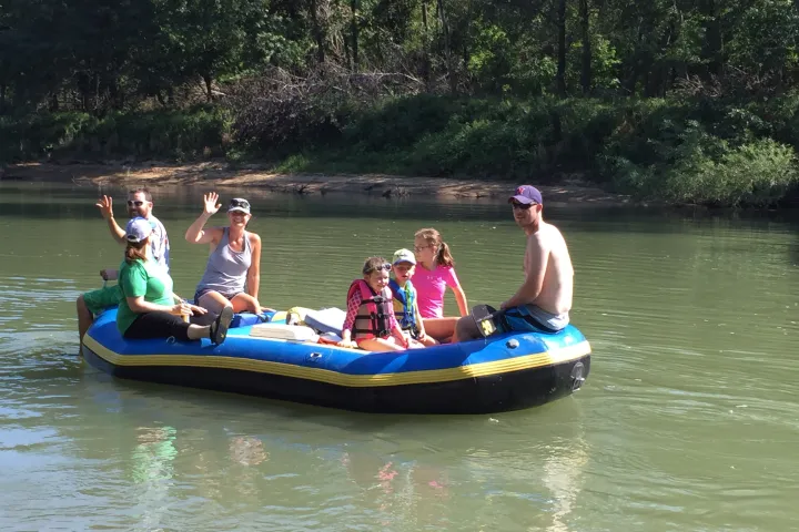 A family enjoying a raft trip on the Meramec River